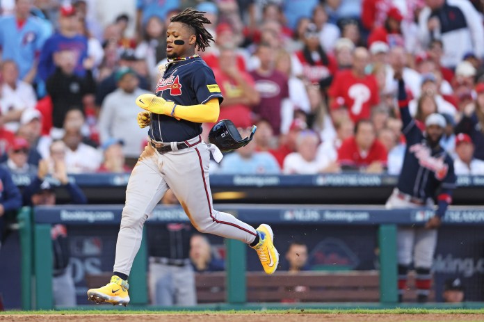 Atlanta Braves right fielder Ronald Acuna Jr. scores a run on a hit by second baseman Ozzie Albies.