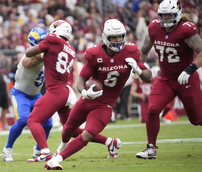 Arizona Cardinals running back James Conner (6) runs against the Los Angeles Rams during the first quarter at State Farm Stadium on September 15, 2024.