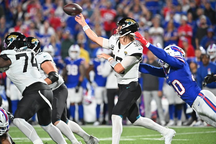 Jacksonville Jaguars quarterback Trevor Lawrence (16) throws a pass under pressure from Buffalo Bills linebacker Von Miller (40) in the fourth quarter at Highmark Stadium on September 23, 2024.