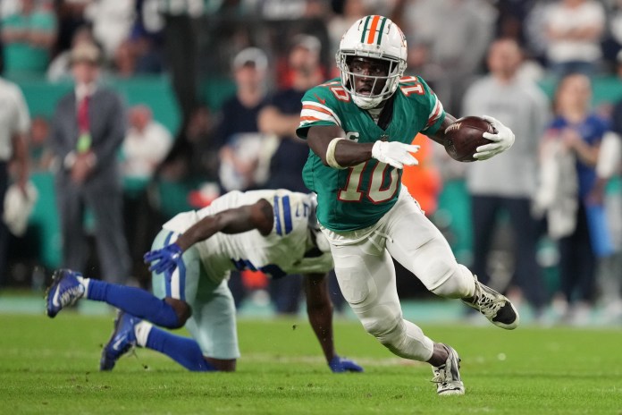 Miami Dolphins wide receiver Tyreek Hill (10) picks up a first down on the Dolphins' final drive, leading to a game-winning field goal against the Dallas Cowboys during an NFL game at Hard Rock Stadium in Miami Gardens, Dec. 24, 2023.