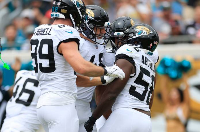 Jacksonville Jaguars linebacker Yasir Abdullah (56) is celebrated by linebacker Chad Muma (48) for his defensive stop with tight end Luke Farrell (89) during the first quarter of the NFL football matchup on September 15, 2024, at EverBank Stadium in Jacksonville, Fla. The Browns defeated the Jaguars 18-13.