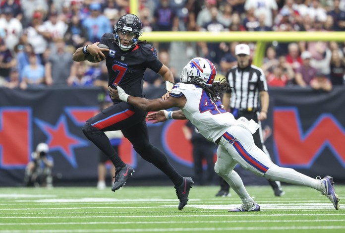 Houston Texans quarterback C.J. Stroud (7) runs with the ball as Buffalo Bills linebacker Dorian Williams (42) attempts to make a tackle during the fourth quarter at NRG Stadium on October 6, 2024.