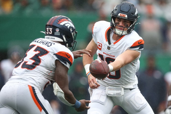 Denver Broncos quarterback Bo Nix (10) hands off to running back Javonte Williams (33) during the second half against the New York Jets at MetLife Stadium on September 29, 2024.