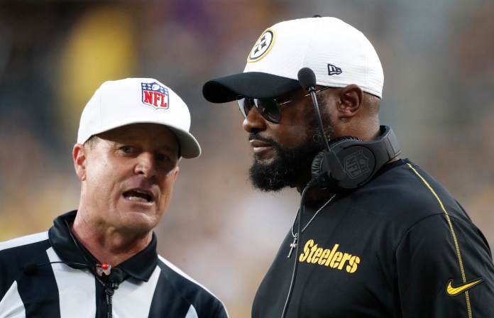Pittsburgh Steelers head coach Mike Tomlin (right) listens to referee Shawn Hochuli (83) during the second quarter of the game against the Buffalo Bills at Acrisure Stadium on August 17, 2024.