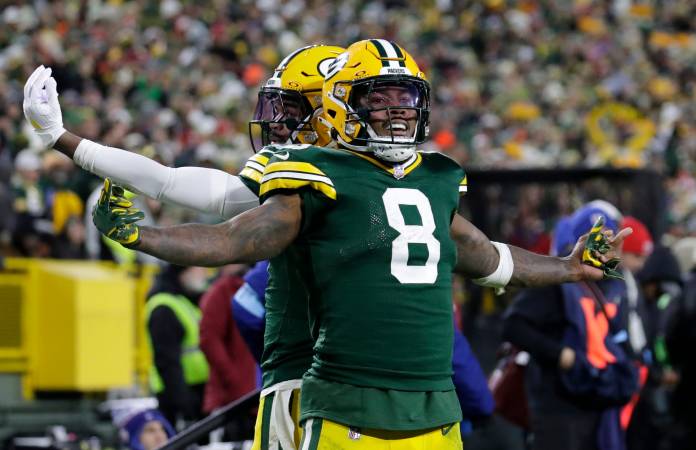 Green Bay Packers running back Josh Jacobs celebrates scoring a touchdown with wide receiver Bo Melton against the San Francisco 49ers