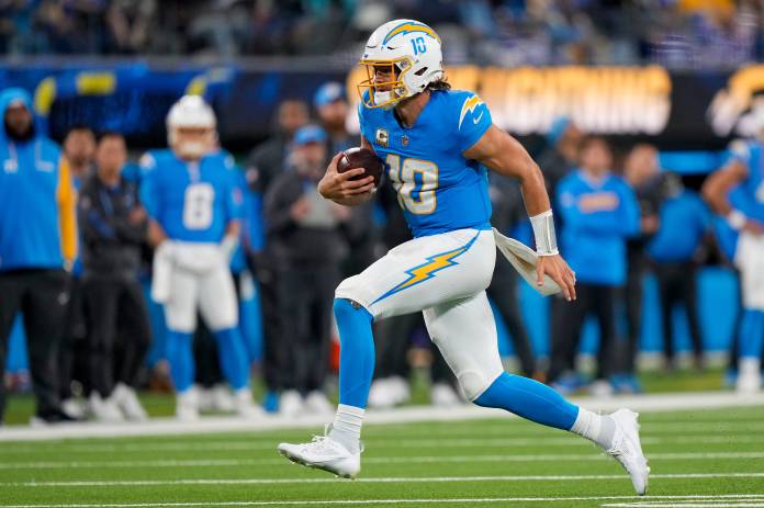 Los Angeles Chargers quarterback Justin Herbert breaks away on a run in the fourth quarter of the NFL Week 11 game