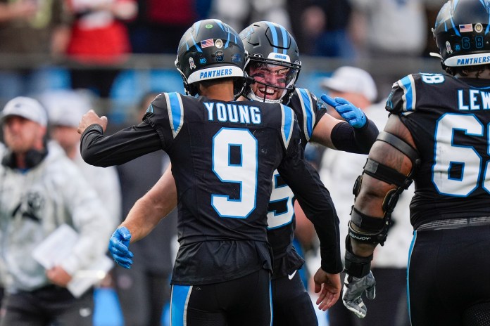 Carolina Panthers quarterback Bryce Young (9) is congratulated by wide receiver Adam Thielen after his touchdown drive against the Kansas City Chiefs during the second half at Bank of America Stadium
