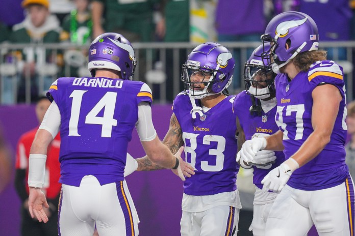Minnesota Vikings wide receiver Jalen Nailor (83) celebrates his touchdown with quarterback Sam Darnold (14) during the second quarter against the Green Bay Packers at U.S. Bank Stadium on December 29, 2024.