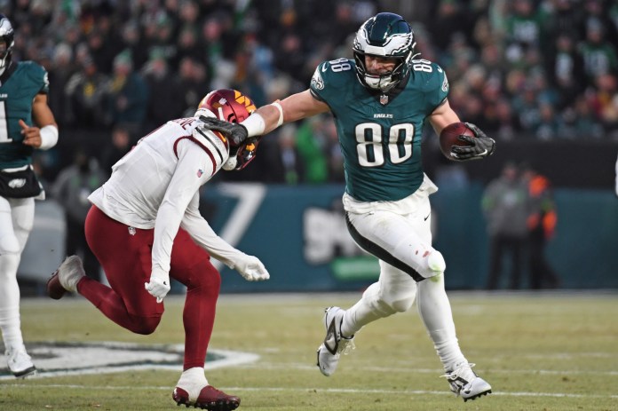 Philadelphia Eagles tight end Dallas Goedert (88) tries to get past Washington Commanders cornerback Mike Sainristil (0) in the NFC Championship game at Lincoln Financial Field